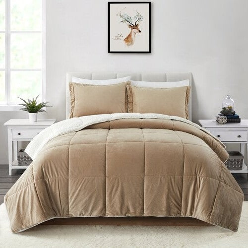 Beige queen comforter with quilted design and matching pillows in a modern bedroom with white furniture and decor