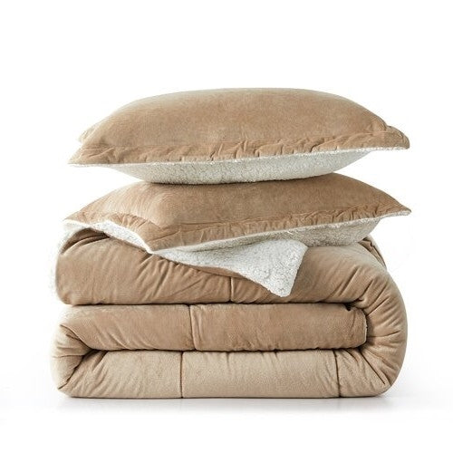 Stacked beige bedding set including comforter and pillows with a soft, textured fabric in a minimalist bedroom